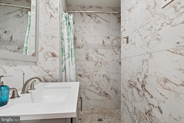 bathroom featuring vanity and tiled shower