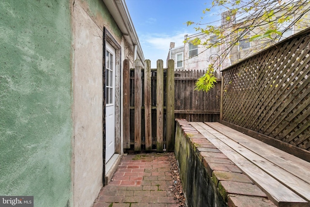 view of side of home featuring fence