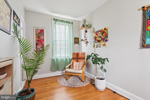 living area with wood finished floors and baseboards