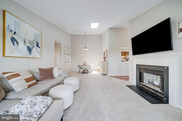 8818 Tanglewood Ln, Manassas, VA 20110 - living room featuring a fireplace with flush hearth, carpet flooring, baseboards, a chandelier, and a high ceiling