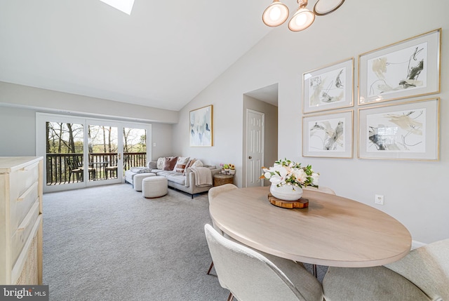 8818 Tanglewood Ln, Manassas, VA 20110 - carpeted dining space with high vaulted ceiling and a notable chandelier