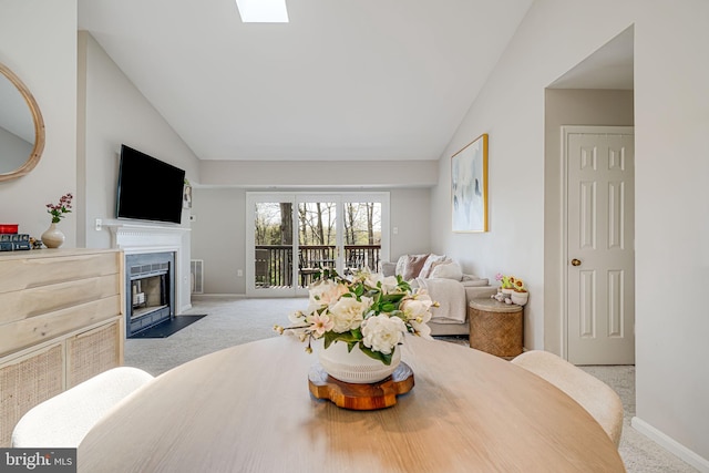 8818 Tanglewood Ln, Manassas, VA 20110 - carpeted living room with a fireplace with flush hearth, vaulted ceiling, visible vents, and baseboards