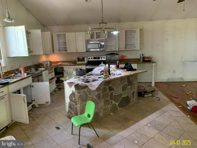 kitchen with vaulted ceiling, open shelves, light tile patterned flooring, stainless steel appliances, and pendant lighting