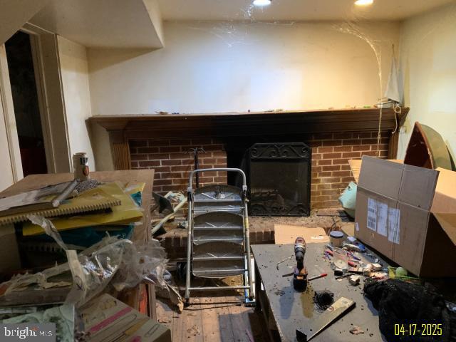 misc room featuring a brick fireplace, recessed lighting, and wood-type flooring