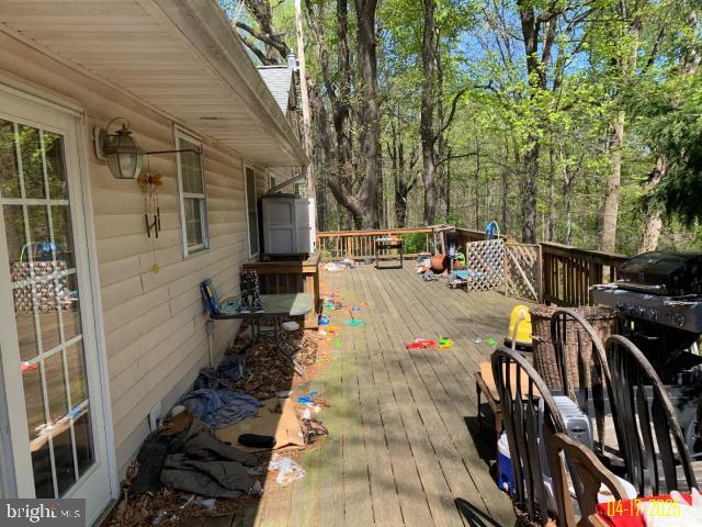 wooden deck featuring an outdoor structure and a shed