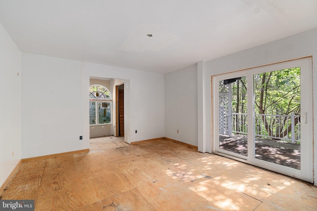 unfurnished room with baseboards