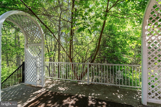 wooden deck featuring a view of trees