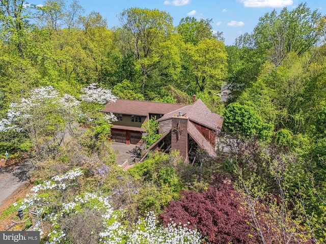 drone / aerial view with a wooded view