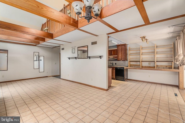 interior space with light tile patterned floors, an inviting chandelier, open floor plan, and dishwasher