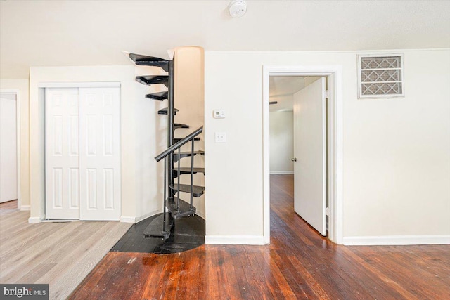 interior space featuring wood finished floors and baseboards