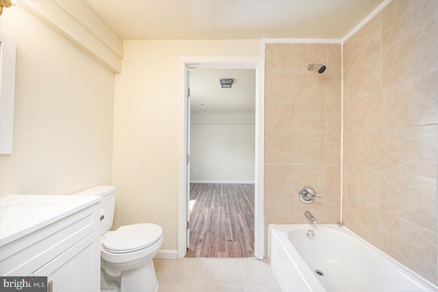 full bath featuring tile patterned floors, toilet, shower / washtub combination, vanity, and baseboards