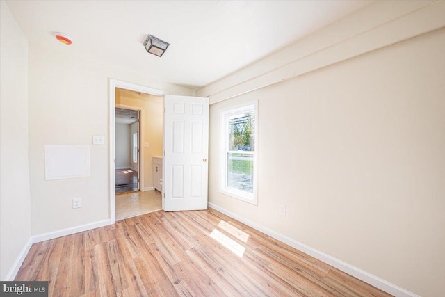 unfurnished bedroom with wood finished floors and baseboards