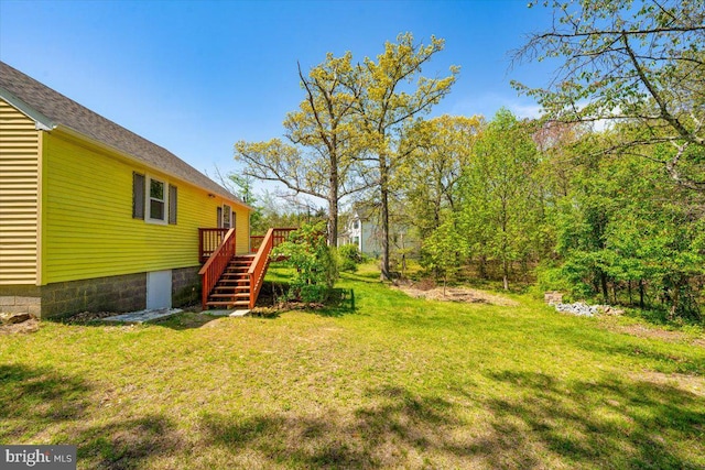 view of yard with a deck and stairway