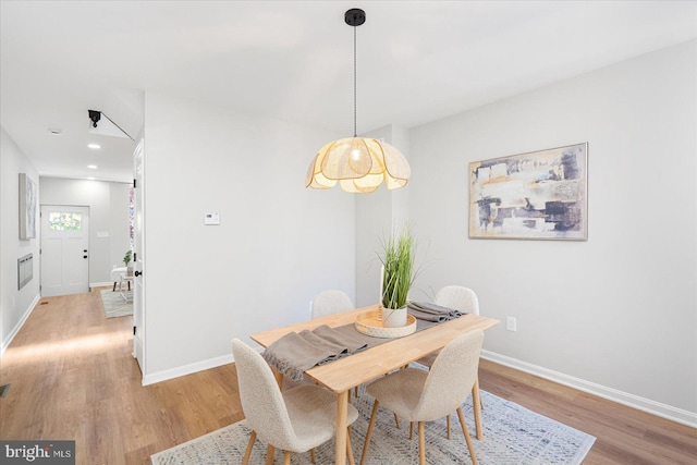 dining room featuring baseboards, recessed lighting, and light wood-style flooring