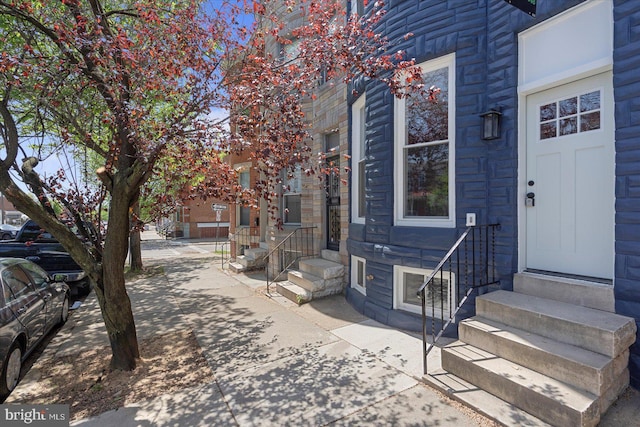 property entrance featuring stone siding