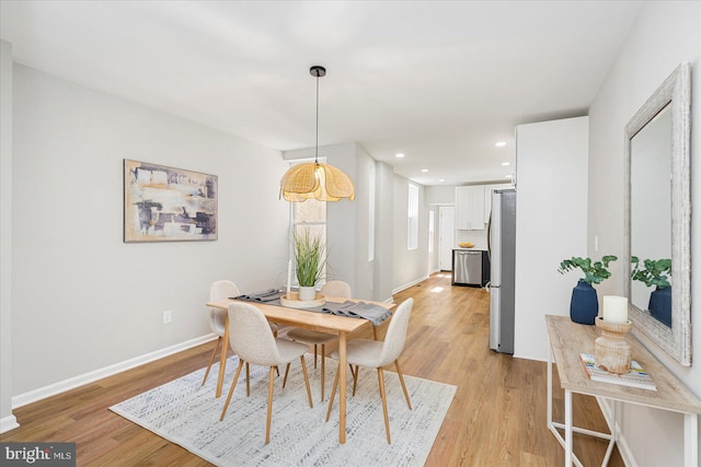 dining room with baseboards, recessed lighting, and light wood finished floors