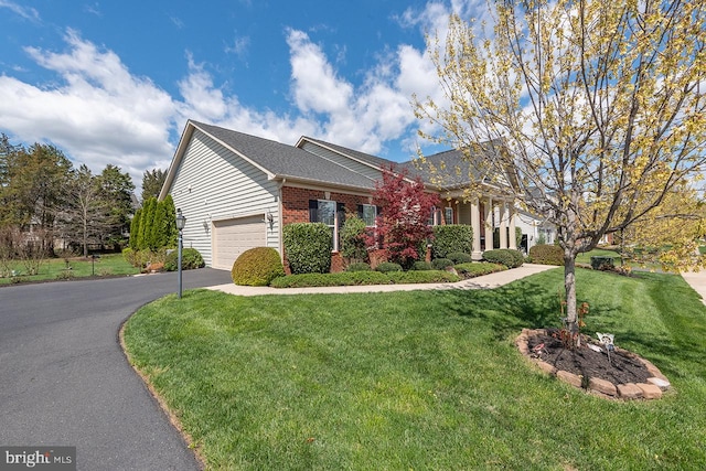 24129 Statesboro Pl, Ashburn, VA 20148 - greek revival house with brick siding, a garage, aphalt driveway, and a front yard