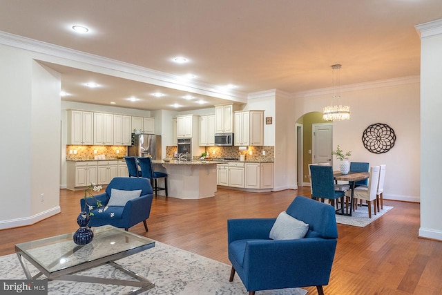 24129 Statesboro Pl, Ashburn, VA 20148 - living area featuring crown molding, arched walkways, light wood-style flooring, baseboards, and recessed lighting
