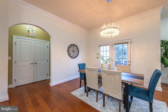 24129 Statesboro Pl, Ashburn, VA 20148 - dining area featuring wood finished floors, arched walkways, a chandelier, and crown molding