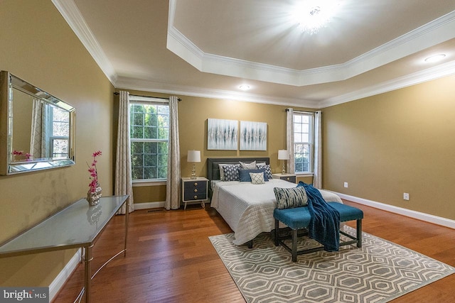 24129 Statesboro Pl, Ashburn, VA 20148 - bedroom featuring baseboards, ornamental molding, wood finished floors, and a raised ceiling