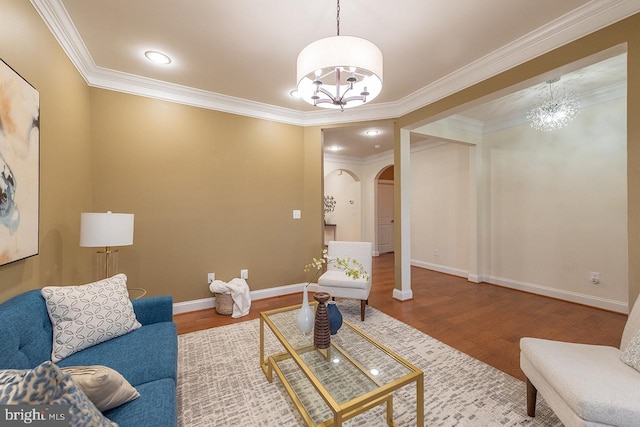 24129 Statesboro Pl, Ashburn, VA 20148 - living room featuring a notable chandelier, wood finished floors, arched walkways, baseboards, and ornamental molding