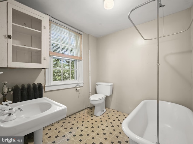 113 Ingleside Ave, Baltimore, MD 21228 - bathroom with radiator, a soaking tub, toilet, and a sink