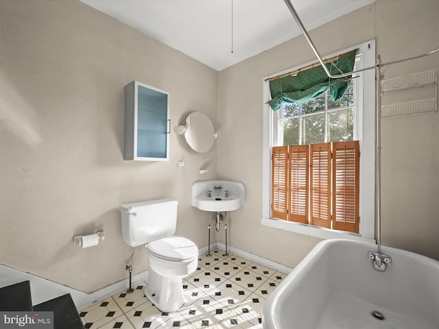 113 Ingleside Ave, Baltimore, MD 21228 - full bathroom with toilet, a soaking tub, and baseboards