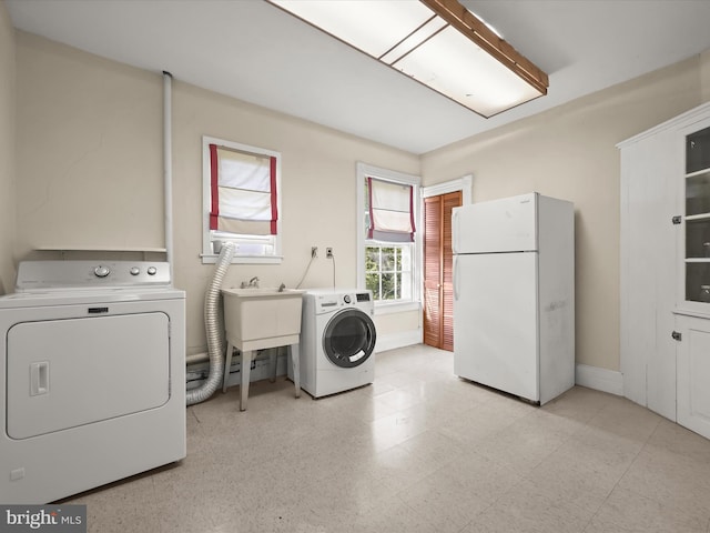 113 Ingleside Ave, Baltimore, MD 21228 - laundry area featuring washing machine and clothes dryer, baseboards, and light flooring