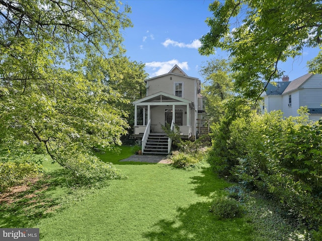 113 Ingleside Ave, Baltimore, MD 21228 - rear view of property featuring a lawn, stairway, and a deck