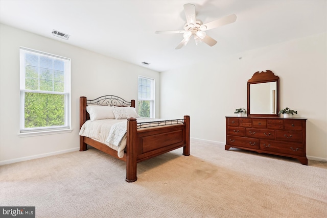 bedroom with baseboards, ceiling fan, and light colored carpet
