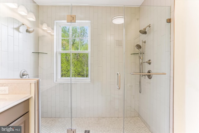 full bathroom with a shower stall, a wealth of natural light, and vanity