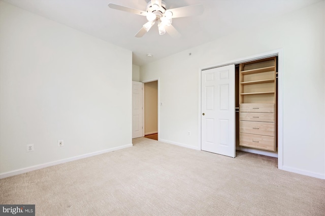 unfurnished bedroom with a ceiling fan, baseboards, light carpet, and a closet