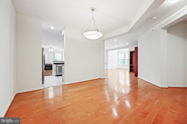 interior space with recessed lighting, baseboards, a ceiling fan, and light wood-type flooring