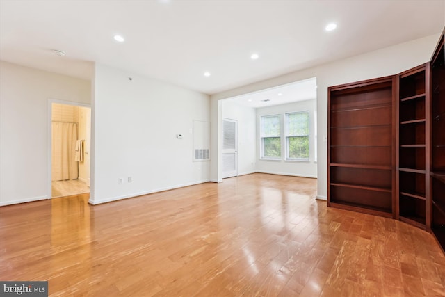 unfurnished living room featuring visible vents, recessed lighting, light wood finished floors, and baseboards
