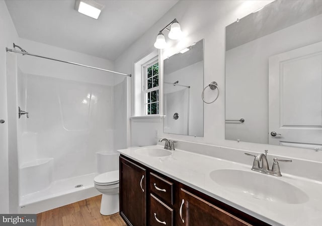 21 American Ave, Carlisle, PA 17013 - full bathroom featuring toilet, wood finished floors, a sink, and a shower