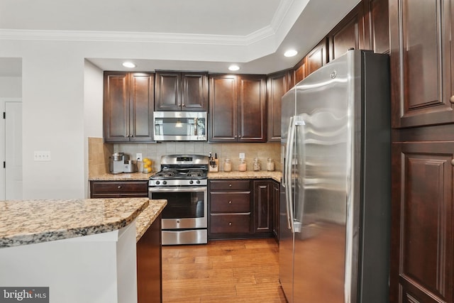 42250 Tackroom Ter, Aldie, VA 20105 - kitchen with appliances with stainless steel finishes, tasteful backsplash, dark brown cabinets, light wood finished floors, and ornamental molding