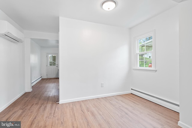 empty room featuring a baseboard heating unit, a wall mounted air conditioner, and wood finished floors