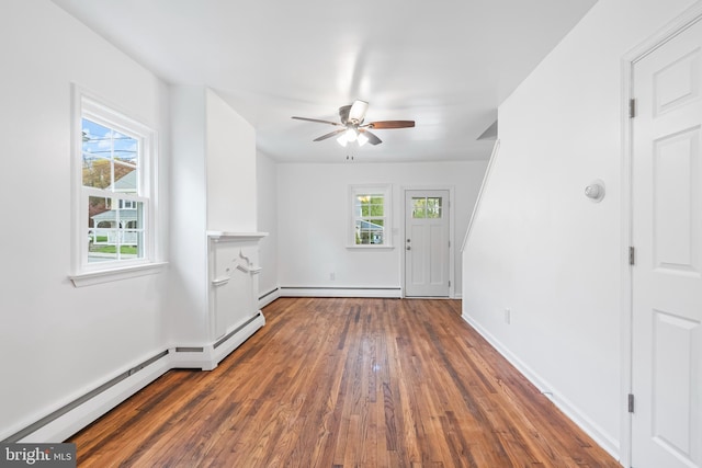 unfurnished living room with a baseboard radiator, baseboards, wood finished floors, and ceiling fan