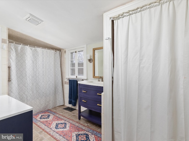 full bath with vaulted ceiling, visible vents, and vanity