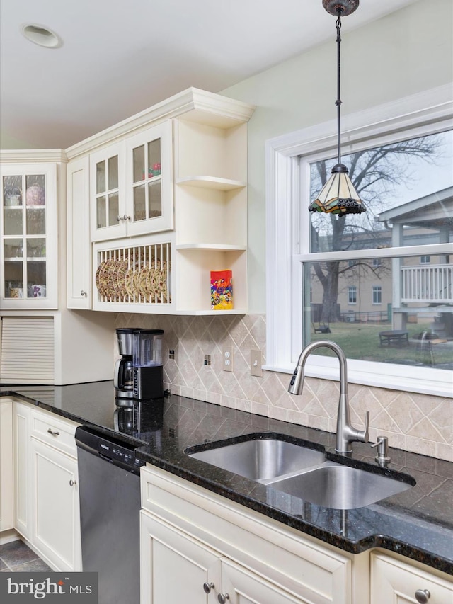kitchen with backsplash, dishwasher, a sink, hanging light fixtures, and white cabinetry