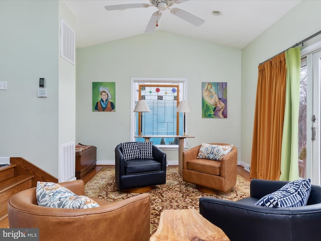 living area with visible vents, vaulted ceiling, wood finished floors, and ceiling fan