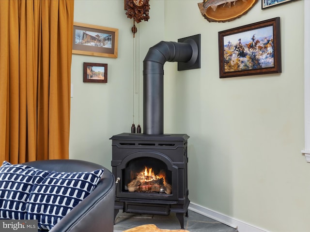 room details with baseboards and a wood stove