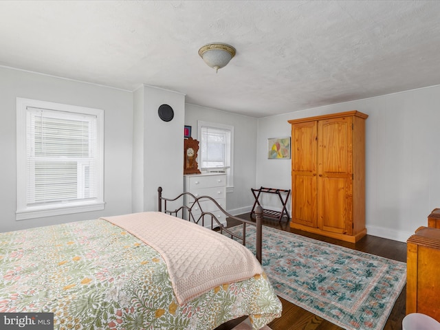 bedroom with wood finished floors and baseboards
