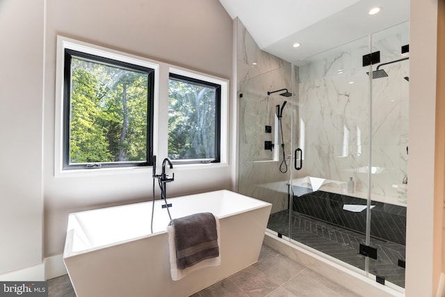 full bath with recessed lighting, vaulted ceiling, a freestanding tub, and a marble finish shower