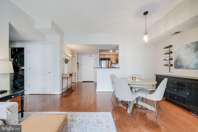 880 N Pollard St Unit 1021, Arlington, VA 22203 - dining space featuring stacked washer / dryer, wood finished floors, and baseboards