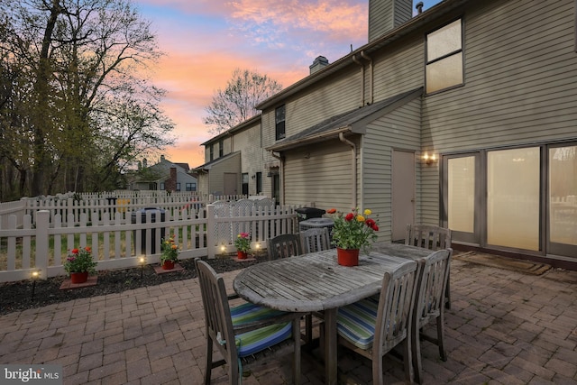 9 Stratton Ct, Robbinsville, NJ 08691 - patio terrace at dusk with outdoor dining area and fence