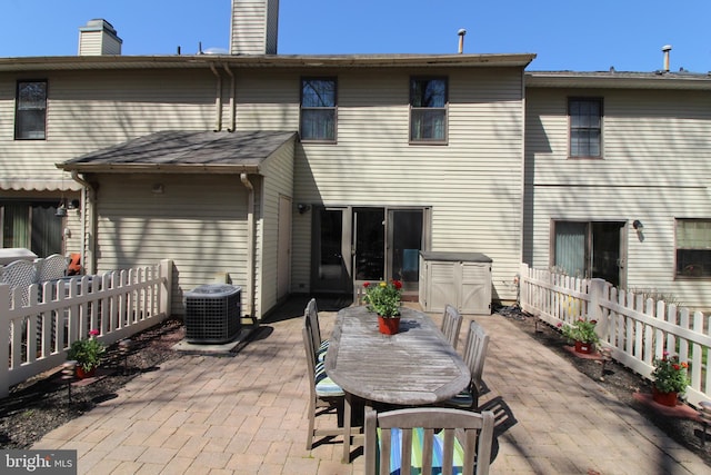 9 Stratton Ct, Robbinsville, NJ 08691 - rear view of property with a chimney, central AC unit, fence, and a patio area