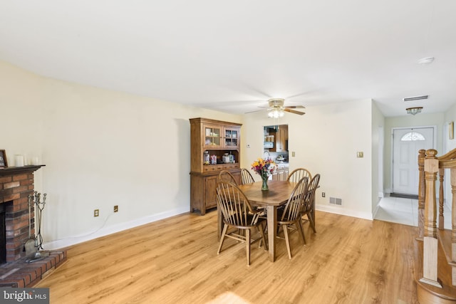 9 Stratton Ct, Robbinsville, NJ 08691 - dining room featuring ceiling fan, baseboards, light wood-style floors, and a fireplace