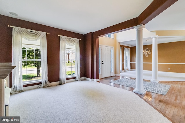 1005 Chaff Way, La Plata, MD 20646 - foyer with ornate columns, a chandelier, carpet flooring, and baseboards