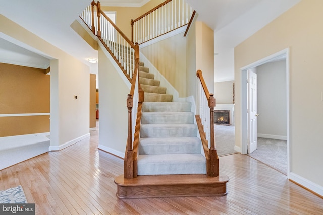 1005 Chaff Way, La Plata, MD 20646 - stairs with baseboards, hardwood / wood-style flooring, ornamental molding, and a brick fireplace